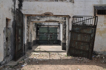 Gate of an abandoned prison in the former Ussher Fort in Accra, Ghana. - obrazy, fototapety, plakaty