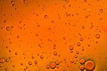 deep orange liquid background of bubbles with movement