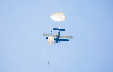 Skydiving. Parachutists jump from a flying plane in the air. Extreme sport and entertainment.