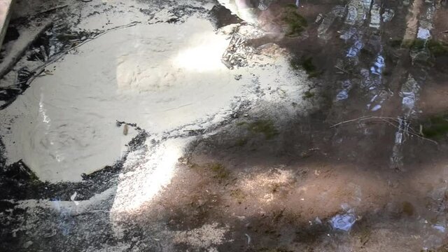 Abstract view of drinkable erupting fresh water source in nature. Natural crystal clear water comes from underground and makes the sand boil. Boiling sand pure water stream in nature