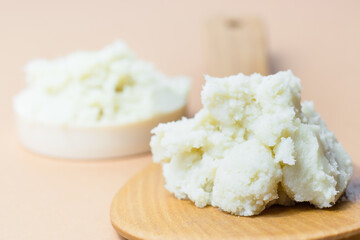 Shea butter on wooden spoon, beautiful, simple composition, unrefined, close up