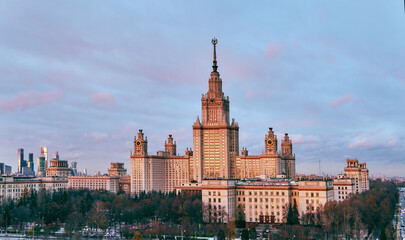 Aerial panoramic view of sunset  campus buildings of famous Moscow university under dramatic cloudy sky in spring with sunlight reflections in windows