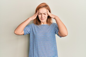 Young caucasian woman wearing casual clothes with hand on head, headache because stress. suffering migraine.