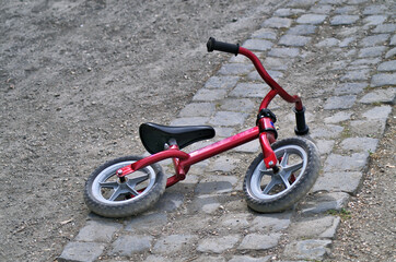 little red bycicle on the ground