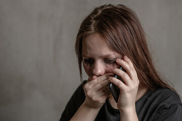 Crying girl talking to using a mobile phone