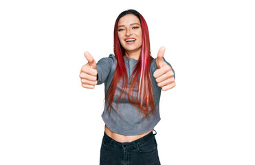 Young caucasian woman wearing casual clothes approving doing positive gesture with hand, thumbs up smiling and happy for success. winner gesture.