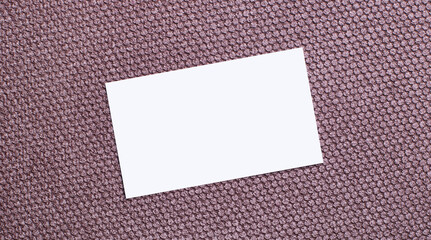 On a brown background, a white rectangular blank card with a place to insert text. Template