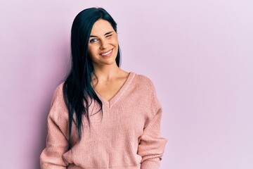Fototapeta premium Young caucasian woman wearing casual clothes winking looking at the camera with sexy expression, cheerful and happy face.