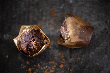 chocolate and vanilla muffins on dark gray background studio low key photography 