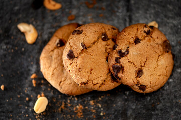 chocolate chip cookies on dark gray background studio dark mood style