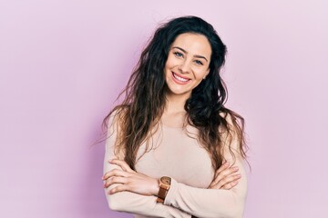 Fototapeta premium Young hispanic woman wearing casual clothes happy face smiling with crossed arms looking at the camera. positive person.