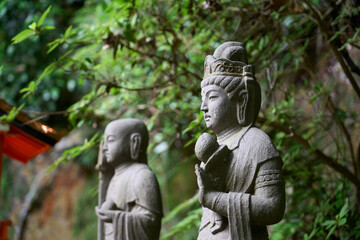 Fototapeta na wymiar Two Buddha statues standing in the forest