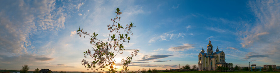 Colorful sunrise over the church in summer