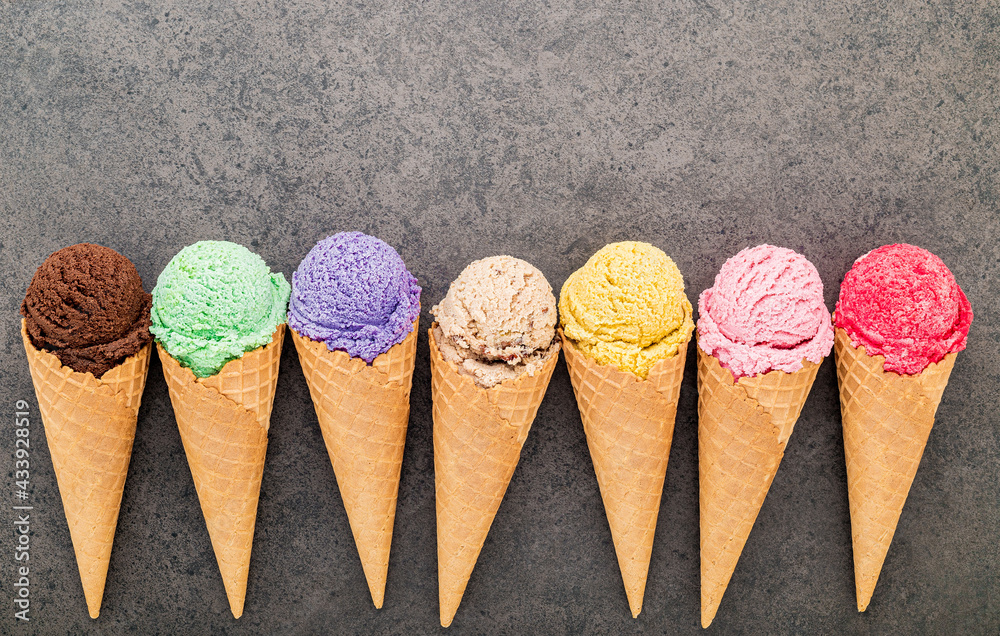 Poster flat lay various of ice cream cones set up on dark stone background. summer and sweet menu concept.