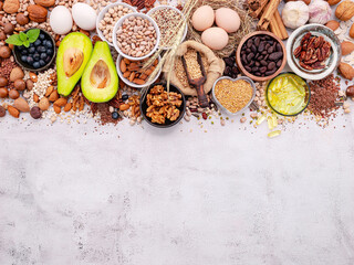 Ingredients for the healthy foods selection. The concept of superfoods set up on white shabby concrete background with copy space.