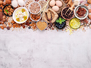 Fototapeta na wymiar Ingredients for the healthy foods selection. The concept of superfoods set up on white shabby concrete background with copy space.