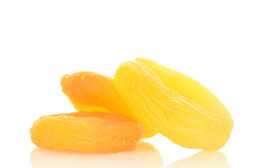 Several bright golden dried apricots, close-up, isolated on white.