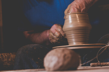 Hands making ceramic pot