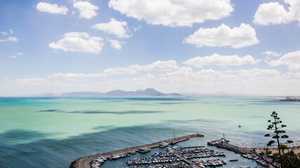Beautiful view of Sidi Bousaid port in Tunis with a blue cloudy sky and a turquoise sea