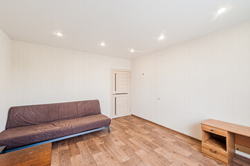 Russia, Moscow- April 28, 2020: interior room apartment bright cozy atmosphere. general cleaning, home decoration, preparation of house for sale. living room with sofa. lamp chandelier on the ceiling