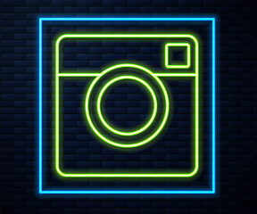Glowing neon line Photo camera icon isolated on brick wall background. Foto camera. Digital photography. Vector