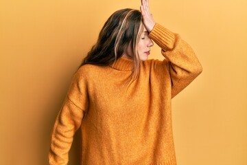 Young blonde woman wearing casual clothes surprised with hand on head for mistake, remember error....