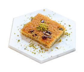 On a marble plate kadayıf dessert isolated on a white background