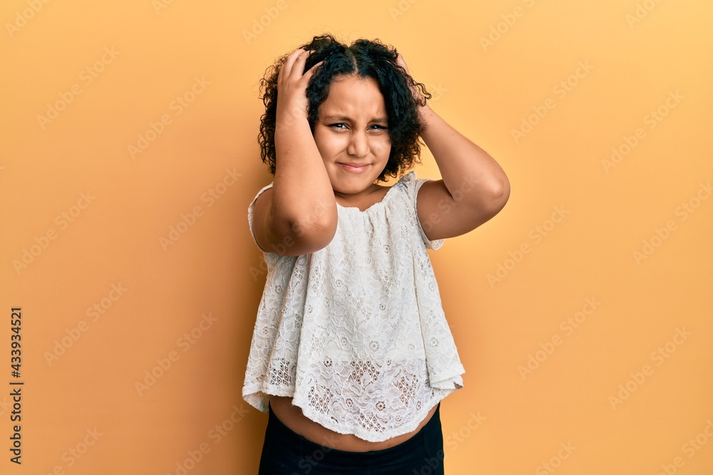 Poster Young little girl with afro hair wearing casual clothes suffering from headache desperate and stressed because pain and migraine. hands on head.