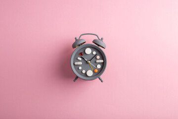 Creative healthcare and medicine concept - clock with drugs and pills.Right time for using...