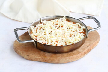 Tomato and peppered egg with cheddar on grated wooden background