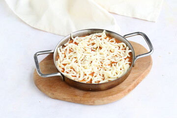 Tomato and peppered egg with cheddar on grated wooden background