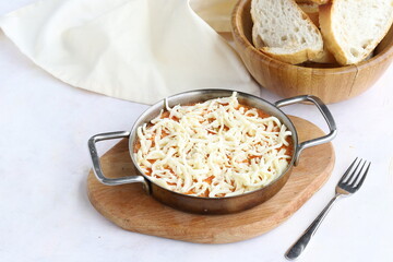 Tomato and peppered egg with cheddar on grated wooden background