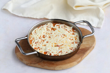 Tomato and peppered egg with melted cheese on wooden background
