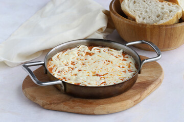 Tomato and peppered egg with melted cheese on wooden background