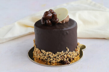 Pistachio and chocolate cake on wooden background