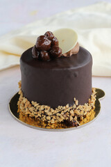 Pistachio and chocolate cake on wooden background