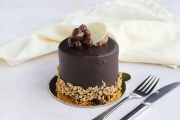 Pistachio and chocolate cake on wooden background