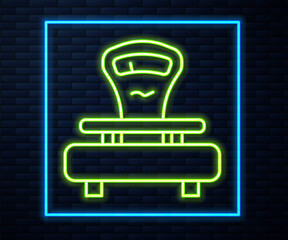 Glowing neon line Scales icon isolated on brick wall background. Weight measure equipment. Vector