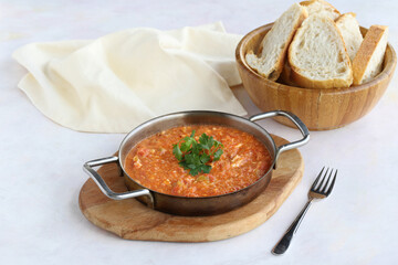 Tomato and peppered egg on wooden background. Local name menemen