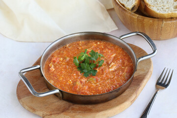 Tomato and peppered egg on wooden background. Local name menemen
