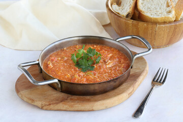 Tomato and peppered egg on wooden background. Local name menemen