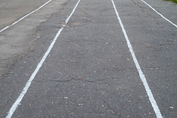 Fototapeta premium Asphalt texture with white lines