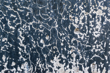 Wall surface with an abstract pattern for the backdrop. Black paint, white plaster.