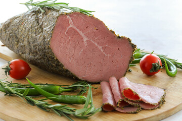 Roast beef on cutting board. Wooden background. local name kekikli roast beef