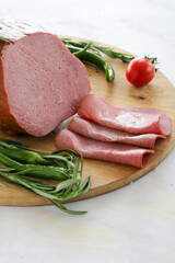 Roast beef on cutting board. Wooden background.