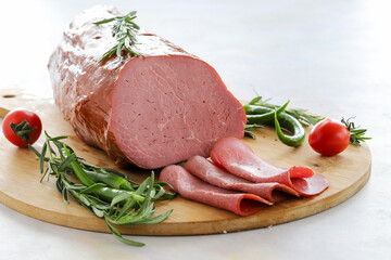 Roast beef on cutting board. Wooden background.
