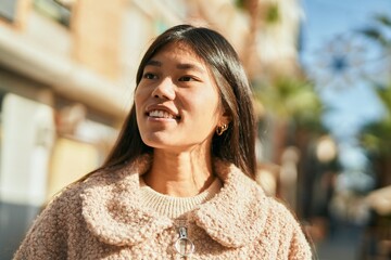 Young asian woman smiling happy standing at the city.