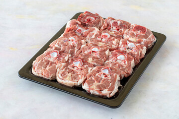 fresh neck of lamb on white wooden background