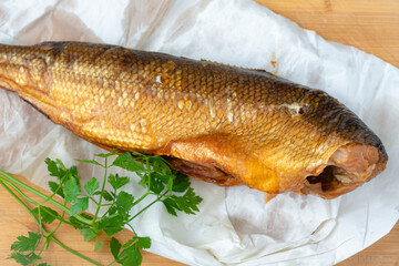 Smoked whitefish on a wooden board.
