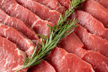 raw boneless veal steak on white wooden background. Close-up beef anricot meat